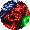 LED ticker sign with scrolling red and green text.