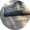 Hermès building plaque on a stone facade.