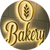 Illuminated bakery sign with wheat emblem.
