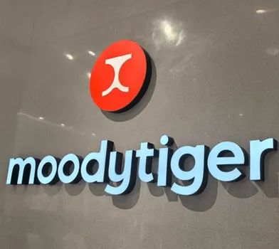 Minimalist wall sign reading 'moodtytiger' with a red circular logo.