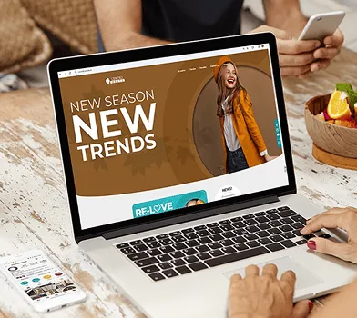 Laptop showing a fashion e-commerce site with seasonal banner and quick purchase options.