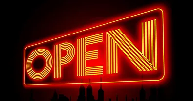 Red neon 'OPEN' sign glowing on a dark background.