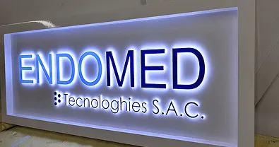 Backlit 'ENDOMED Technologies S.A.C.' wall sign.